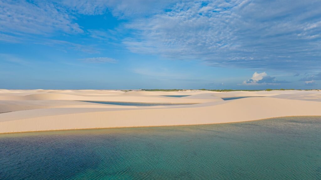 Lagune en duinen onder een blauwe lucht in Lençóis Maranhenses