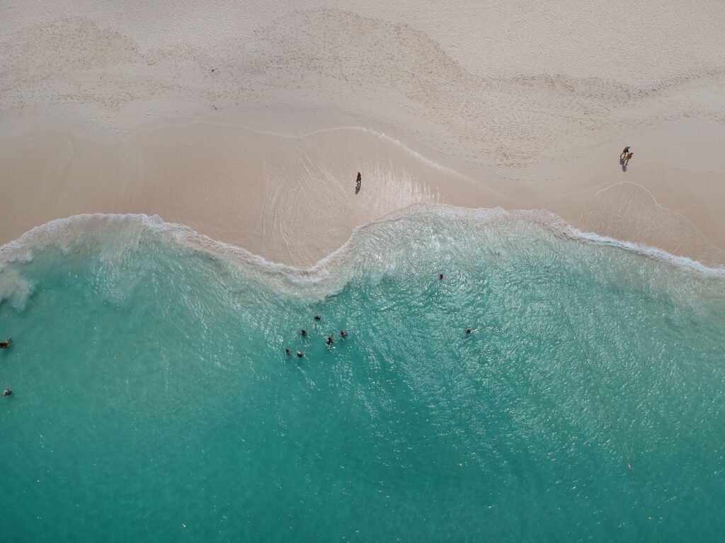 Turquoise water langs het strand van Aruba van bovenaf